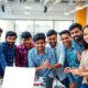 Group of young Indian innovators collaborating in a workspace.