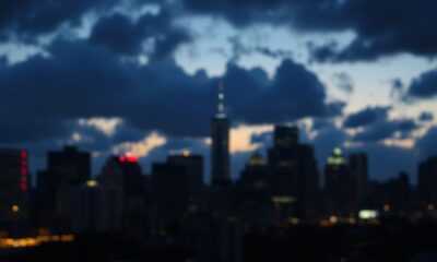 Dim city skyline with dark clouds and low light.