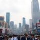 Seoul cityscape with busy streets and cloudy sky.