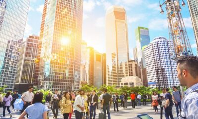 Diverse professionals discussing in front of a city skyline.