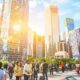 Diverse professionals discussing in front of a city skyline.