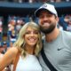 Taylor Swift and Travis Kelce smiling at the U.S. Open.