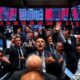 Frantic investors on a chaotic trading floor during market decline.