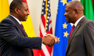 Congo and Rwanda leaders shake hands with flags in background.