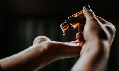 person holding amber glass bottle