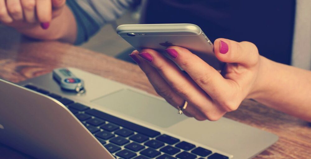 woman holding silver iPhone 6