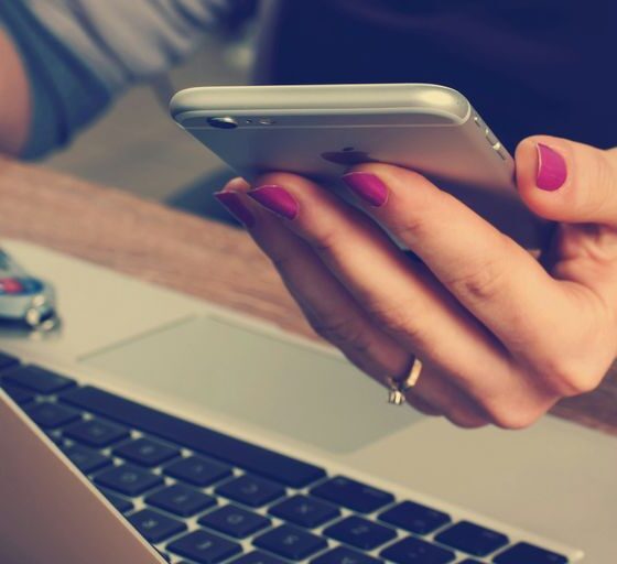 woman holding silver iPhone 6