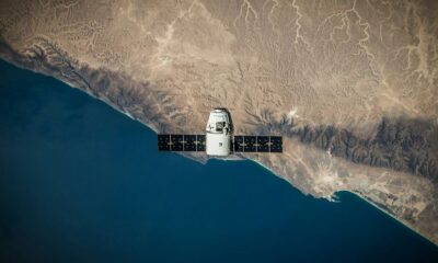 A space satellite hovering above the coastline