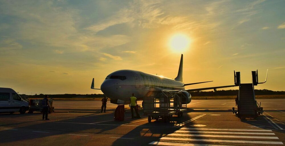 white airplane parked during daytime