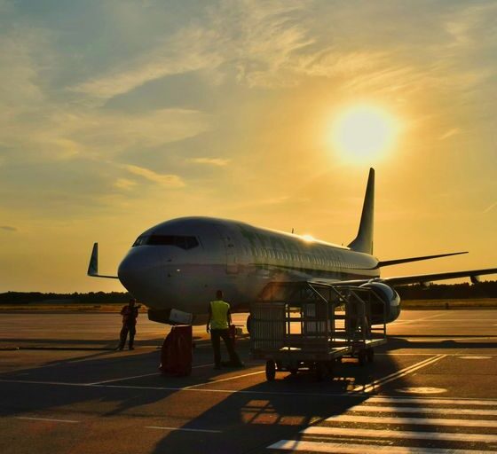white airplane parked during daytime