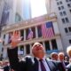 Traders celebrating on Wall Street amidst positive market news.