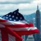 Crumbling American flag against a skyline of uncertainty.