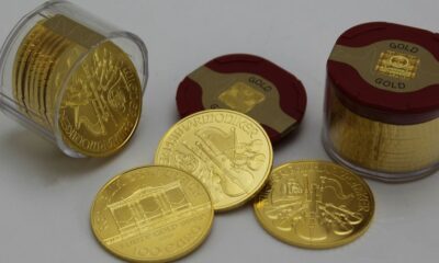 gold round coins on white surface