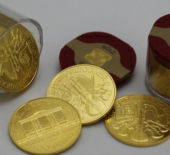 gold round coins on white surface