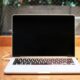 laptop computer beside coffee mug
