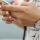 woman holding iPhone during daytime