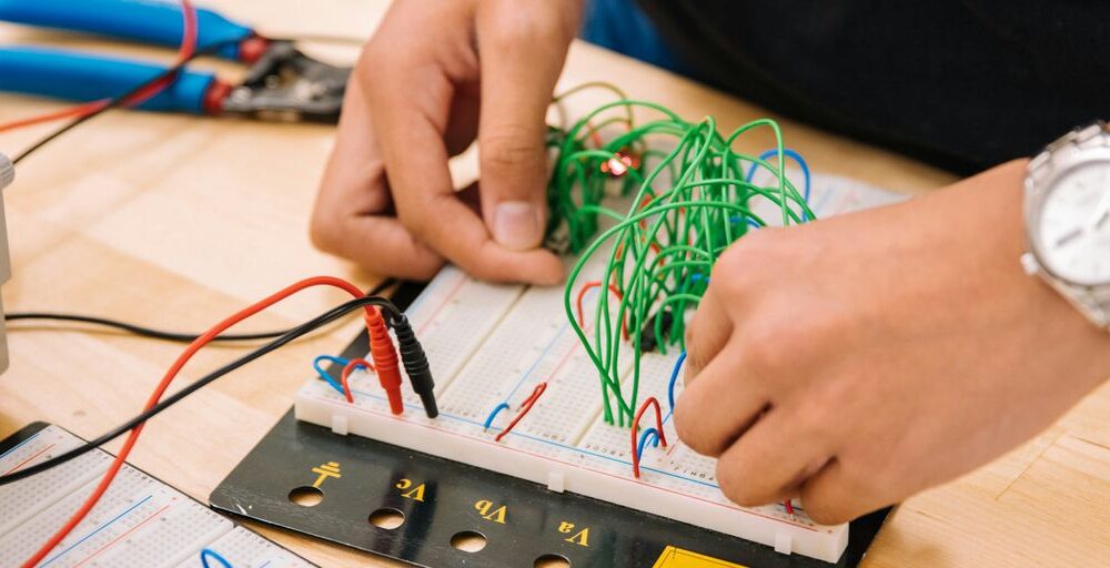 person holding black and white audio mixer