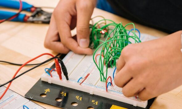 person holding black and white audio mixer