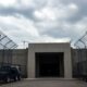 Fortified bunker with security measures and military presence.