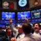 Traders celebrating on a busy stock exchange floor.