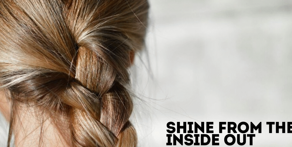 Assorted hair skin and nail vitamins in a hand