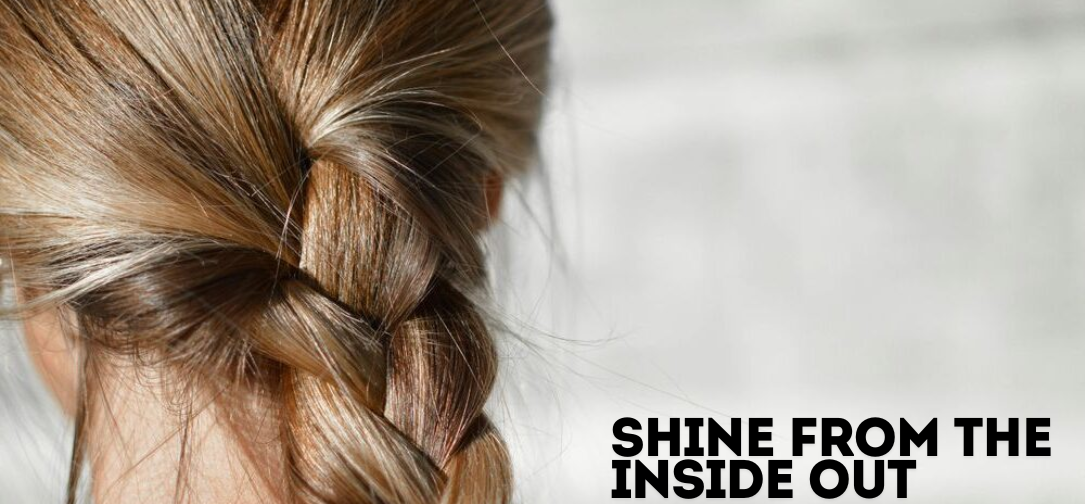 Assorted hair skin and nail vitamins in a hand