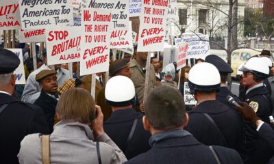 African American demonstrators outside the White House, with signs demanding the right to vote and protesting police brutality against civil rights demonstrators in Selma, Alabama