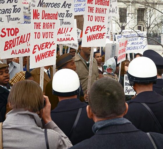 African American demonstrators outside the White House, with signs demanding the right to vote and protesting police brutality against civil rights demonstrators in Selma, Alabama