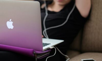 woman sitting on sofa with MacBook Air