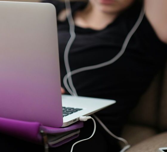 woman sitting on sofa with MacBook Air