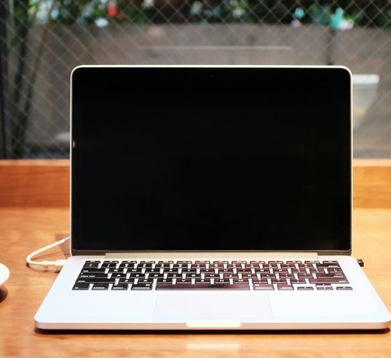 laptop computer beside coffee mug