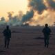 Sudanese soldiers in a war-torn landscape amidst conflict.
