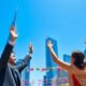 Celebrating traders with skyline backdrop signifying positive trade talks.