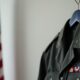 Military uniform with insignia and American flag background.