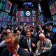 Traders reacting anxiously on a busy stock market floor.