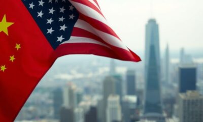 U.S. and Chinese flags intertwined on a city skyline background.