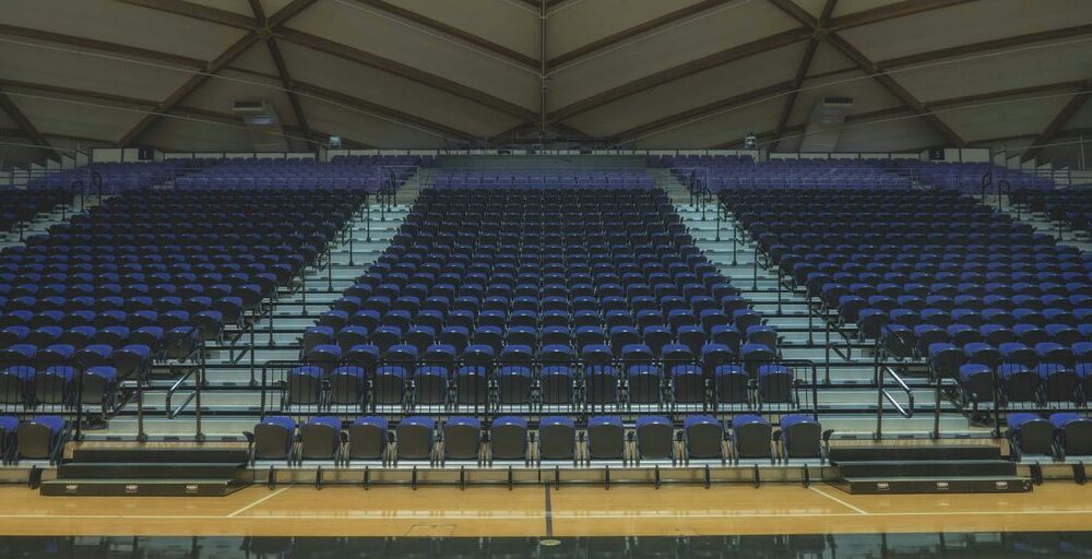 a basketball court with rows of empty seats