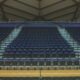 a basketball court with rows of empty seats