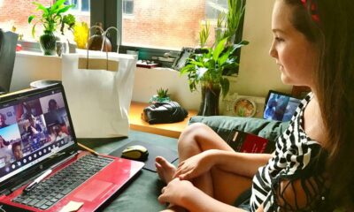 woman in black and white zebra print shirt using macbook pro