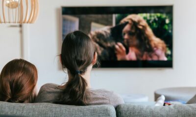 a couple of women sitting on top of a couch