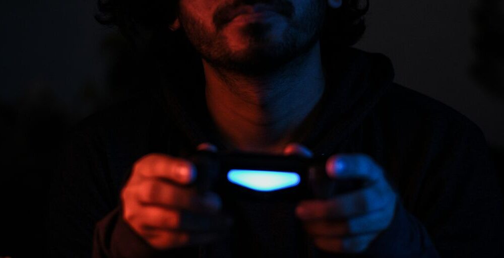 man in black jacket holding black smartphone