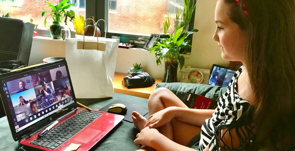 woman in black and white zebra print shirt using macbook pro