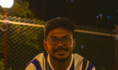 man in black and yellow jersey shirt smiling