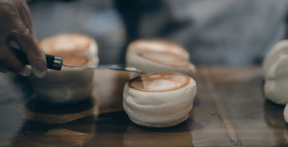a person with a knife cutting into some food