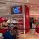 a nintendo store with mario running through the store