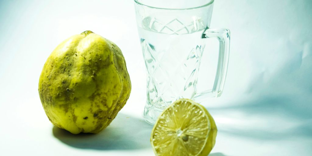 yellow lemon beside clear glass mug