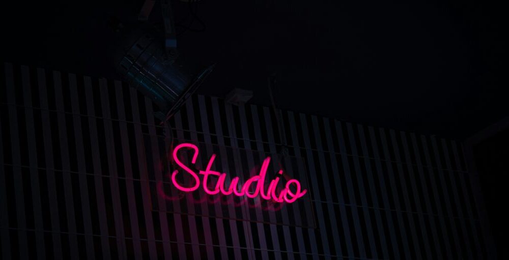 a neon sign that reads studio on the side of a building