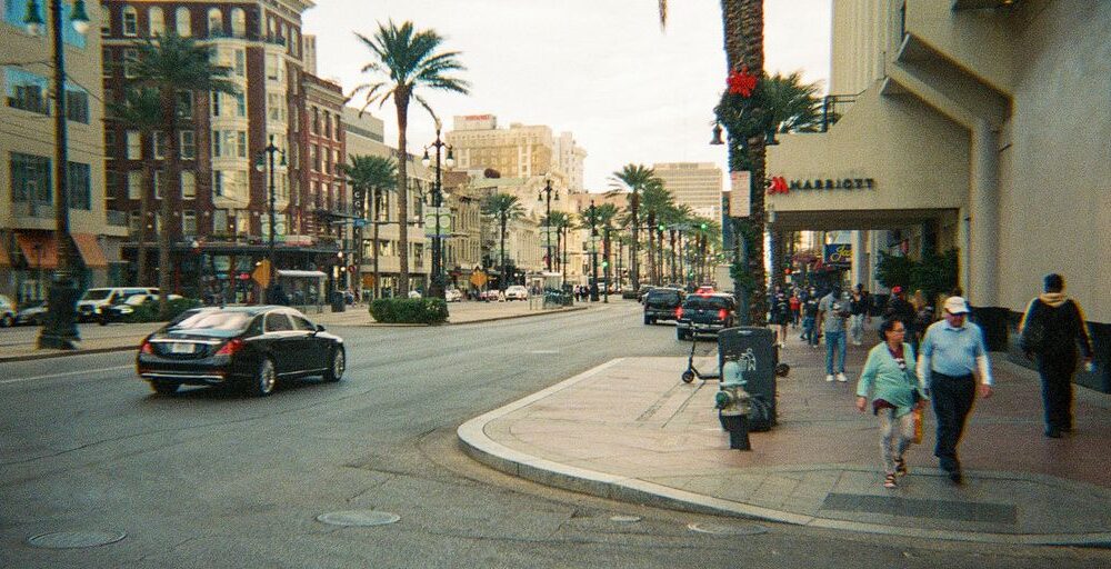 A street scene with buildings and palm trees.