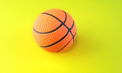 an orange and black basketball on a yellow and green background