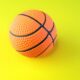 an orange and black basketball on a yellow and green background